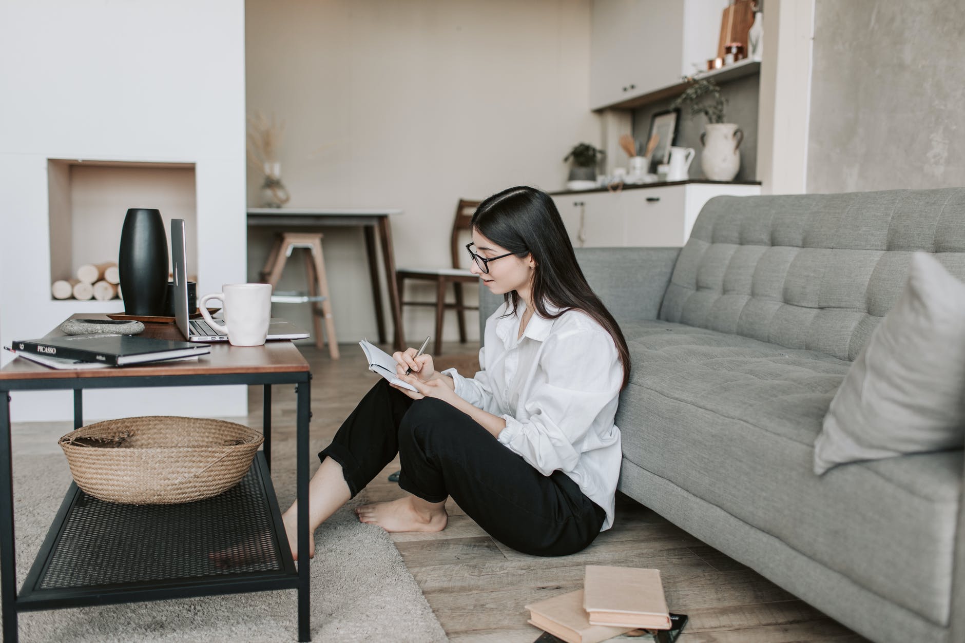 focused young lady sitting on floor in living room